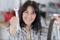 Woman mechanic posing with spanners and tyres Royalty Free Stock Photo