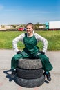 Woman mechanic posing with spanners and tyres Royalty Free Stock Photo