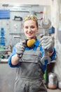 Woman mechanic showing tools to the camera