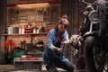 Woman mechanic working on a vintage motorbike