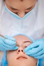 woman during a mechanical face cleansing procedure