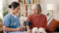 Woman, medical and blood pressure check with nurse, consulting and health issue with vitals, exam or arm. Conversation