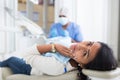 Woman in medical chair complains of toothache to dentist