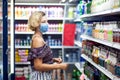 Woman with medical face mask doing one`s shopping in the market. Life during coronavirus time