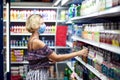 Woman with medical face mask doing one`s shopping in the market. Life during coronavirus time