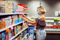 Woman with medical face mask doing one`s shopping in the market. Life during coronavirus time