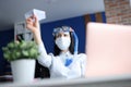 Woman in medical facemask and diving mask launching paper plane Royalty Free Stock Photo