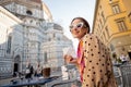 Woman in medical mask at cafe near Duomo cathedral in Florence Royalty Free Stock Photo