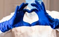 Woman with a medical mask and hands in latex glove shows the symbol of the heart. Doctor for the heart. Love to our pancreas. Love Royalty Free Stock Photo