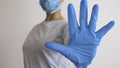 Woman with a medical mask and hands in latex glove shows the symbol STOP. Stop the disease Royalty Free Stock Photo