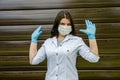 Woman with a medical mask and hands in latex glove shows the symbol STOP. Stop the disease. Royalty Free Stock Photo