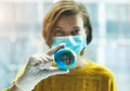 Woman in medical mask holding global earth model in hand in gloves Royalty Free Stock Photo