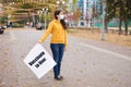 A woman in a medical mask holds a poster that says Vaccinate to live