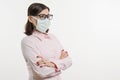 Woman in medical mask, looking at profile, white background, copy space.