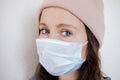 A woman in a medical mask on the quarantine. Portrait of a female in a protective face mask against coronavirus