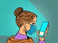 Woman in medical mask reads a smartphone