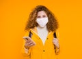 Woman in medical mask traveler holding passport with ticket and credit card. Blue wall back. Travel during the Royalty Free Stock Photo