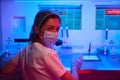 Woman in medical uniform in the workplace in the laboratory