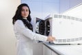 Woman medical worker opens autoclave door. Sterilization of a medical instrument.