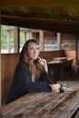 A woman in a medieval cloak sits with a pen Royalty Free Stock Photo