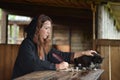 A woman in a medieval cloak sits with a pen and writes. Royalty Free Stock Photo