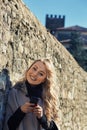 woman in Medieval European city, using phone