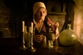 Medieval alchemist in kitchen