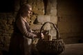 Medieval peasant woman checking food basket