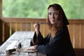 A woman in a medieval cloak sits with a pen Royalty Free Stock Photo