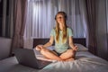 Woman meditates on bed using meditation app. sport, technology and healthy lifestyle concept