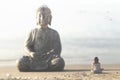 Woman meditates in front of the buddha statue in the middle of nature Royalty Free Stock Photo