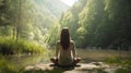 Woman meditates in peace in the outdoors. Serene quiet by a stream. Yoga a lake.