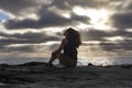 Woman meditating on the beach