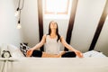 Woman meditating in bedroom at home.Antistress practice.Overcoming anxiety and fear.Mindfullness meditation.Breathing exercise. Royalty Free Stock Photo