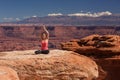 Woman meditating doing yoga in Canyonlands National park in Utah