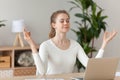 Woman meditating doing yoga sitting at workplace Royalty Free Stock Photo