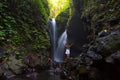 Woman meditating doing yoga between waterfalls Royalty Free Stock Photo