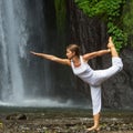 Woman meditating doing yoga between waterfalls Royalty Free Stock Photo