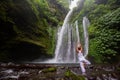 Woman meditating doing yoga between waterfalls Royalty Free Stock Photo