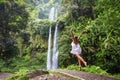 Woman meditating doing yoga between waterfalls Royalty Free Stock Photo