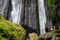 Woman meditating in front of dusun kuning waterfall, Bali Royalty Free Stock Photo