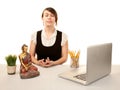 Woman meditating at her desk