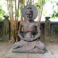 Woman meditating her hair in a emaciated bun at the Indonesian Mendut temple