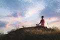 Woman meditating on hill near sea, back view. Space for text Royalty Free Stock Photo
