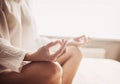 Woman meditating at home. Girl practicing yoga in yoga class.