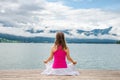 Woman meditating at the lake