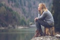 Woman meditating on a lake shore Royalty Free Stock Photo