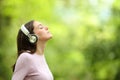 Woman meditating listening audio guide with headphones Royalty Free Stock Photo