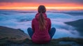 Woman meditating on mountaintop at sunrise Royalty Free Stock Photo