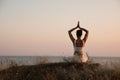 Woman meditating near sea, back view. Space for text Royalty Free Stock Photo